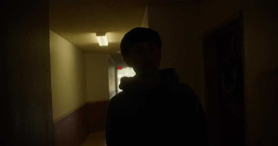 A teenager is walking down the hallway