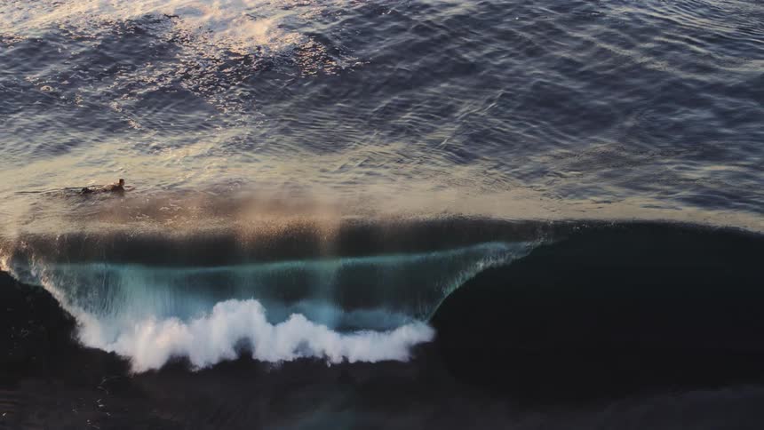 Surfer alone in an ocean with waves