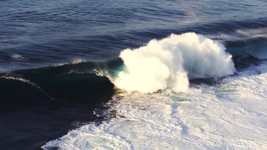 Surfers at dawn at sea