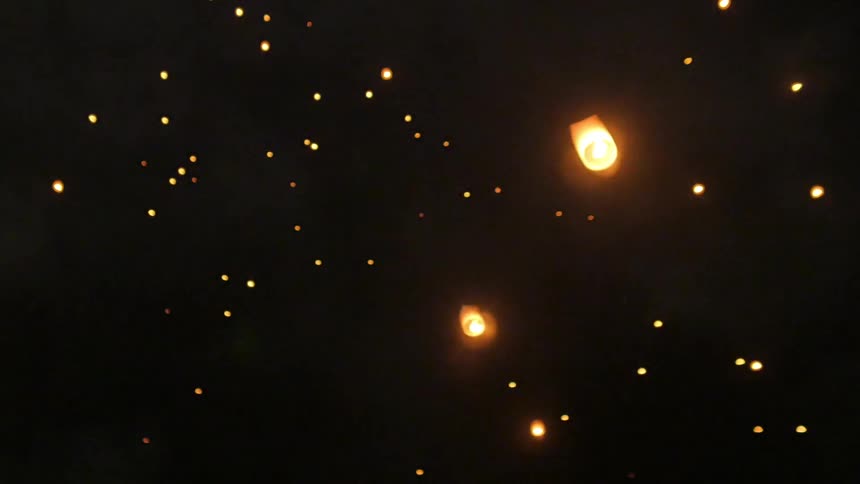 Paper lanterns floating in the sky