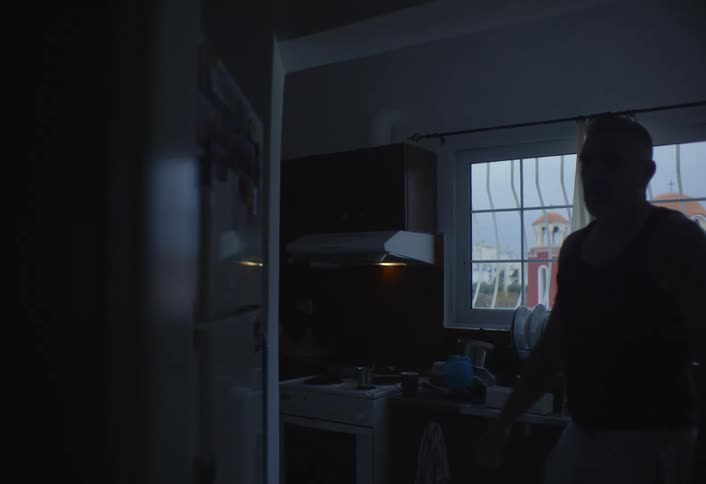 A footage of a man opening a fridge in the kitchen