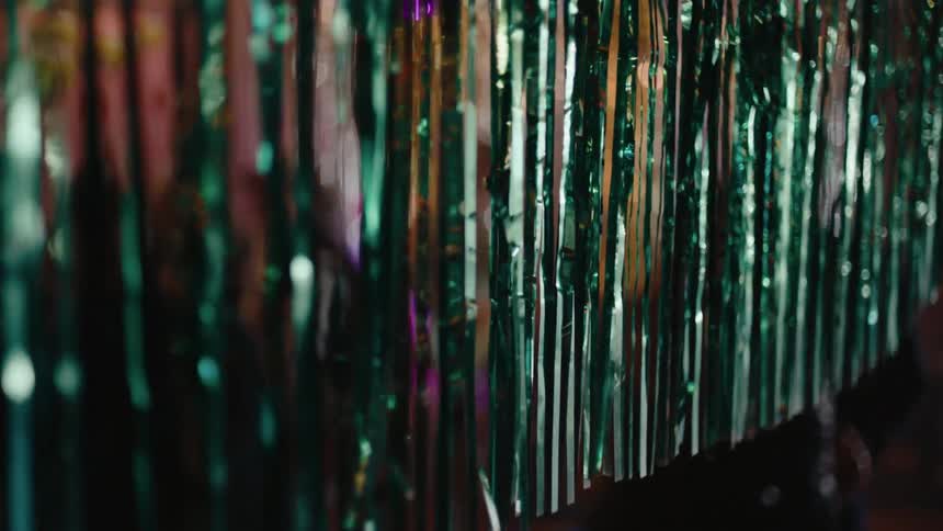 Crystals hang from the ceiling near where a couple is dancing