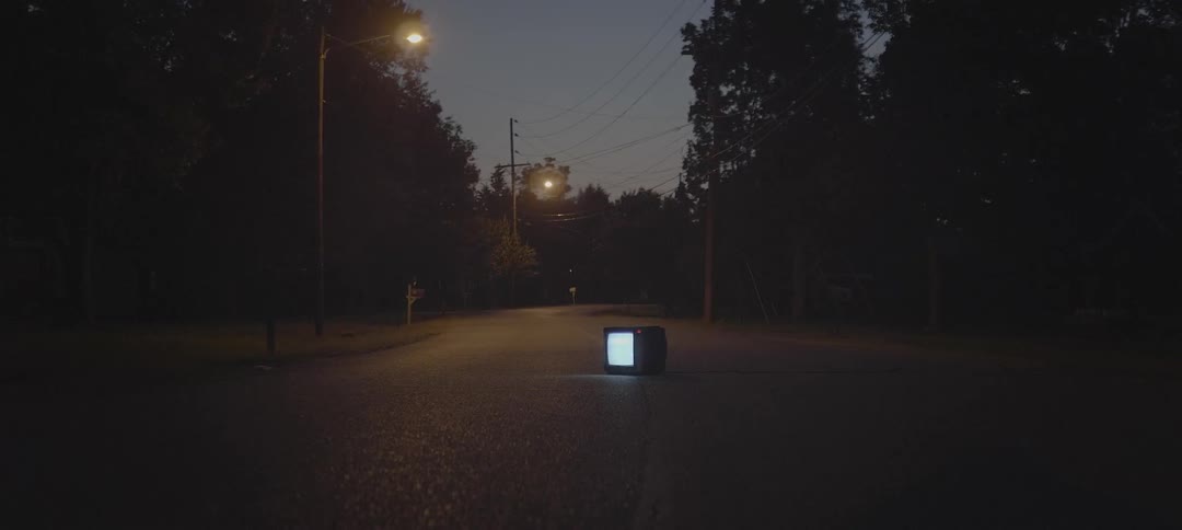 Tv in the middle of a deserted street at night
