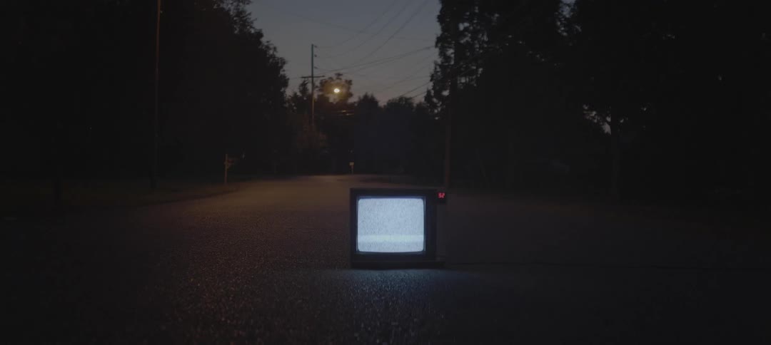 Tv flickering static in the middle of a road at night