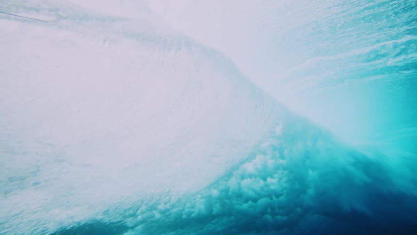 Surfers are riding waves as they form