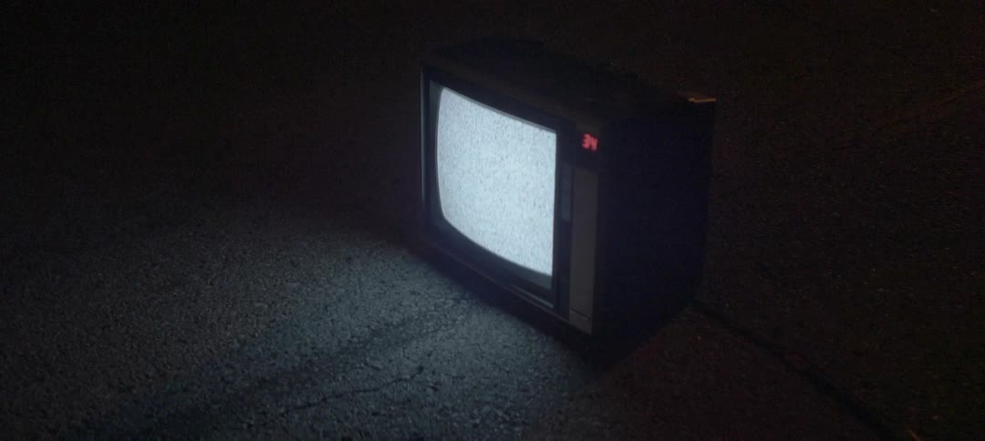 Tv showing static outside on the pavement