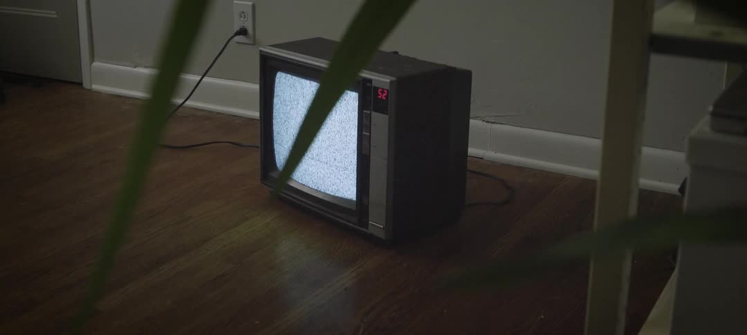 Tv showing static plugged in on the floor