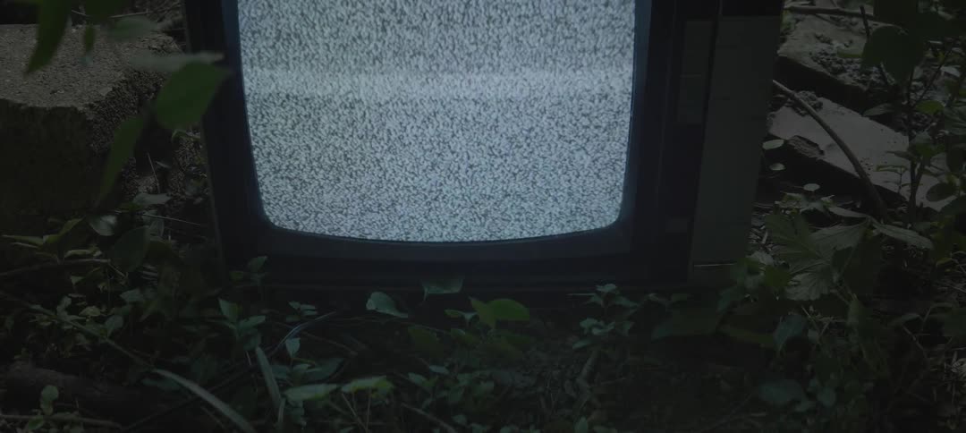 Close up of a tv flickering on the ground