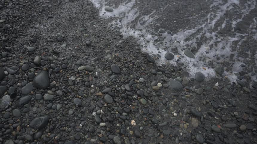 Waves wash up on a rocky beach