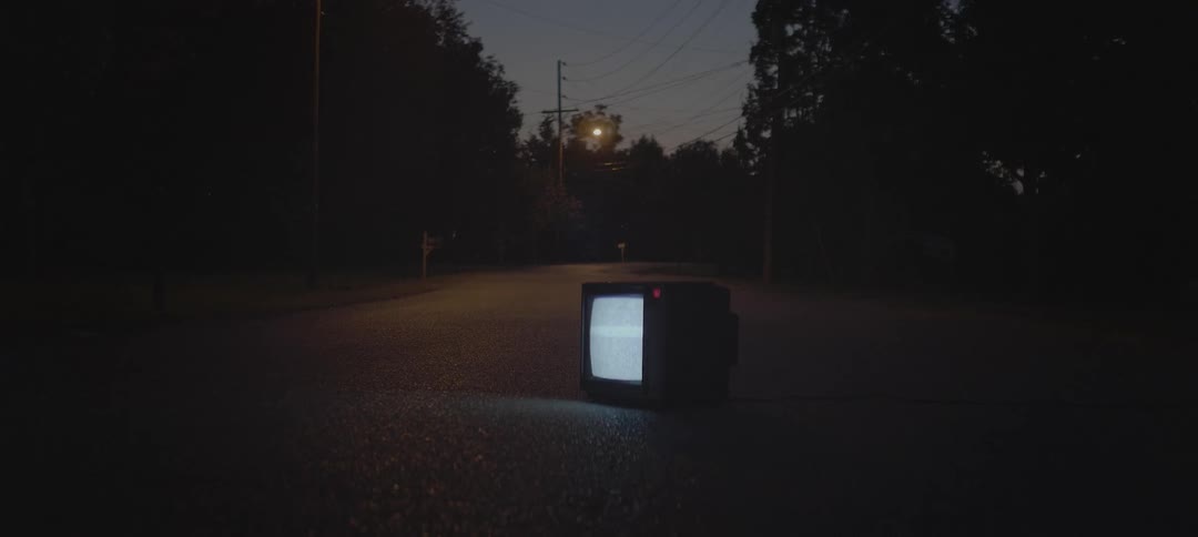 Tv showing static outside on the pavement