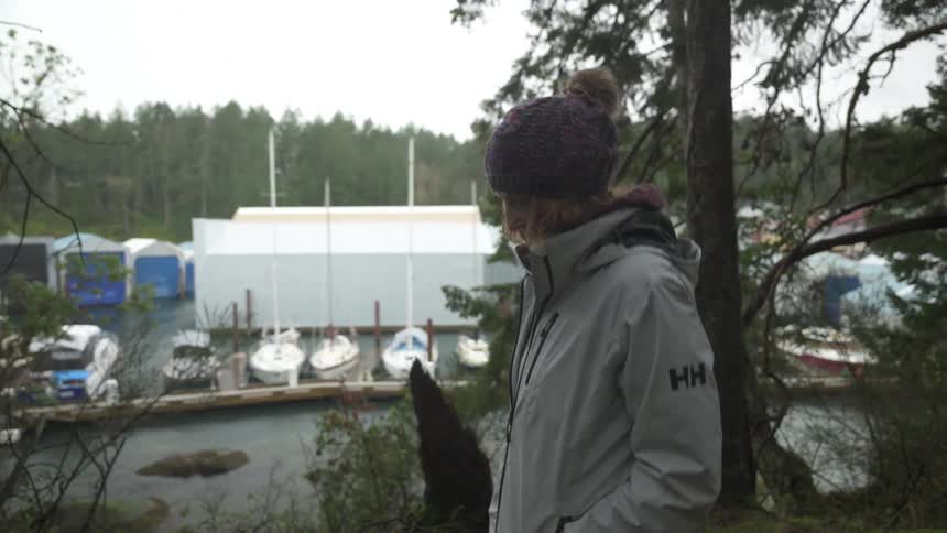 A woman hikes on a trail by the marina