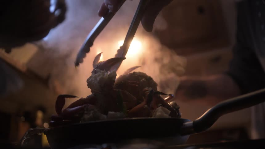 A person is cooking seafood at home