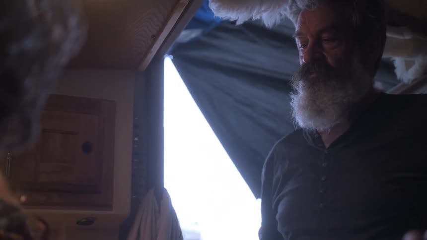 Man cooking inside a cabin
