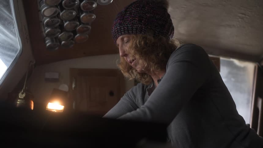Woman cooking in a small kitchen