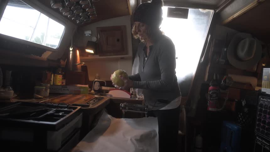 A footage of a lady unwrapping and smelling a food