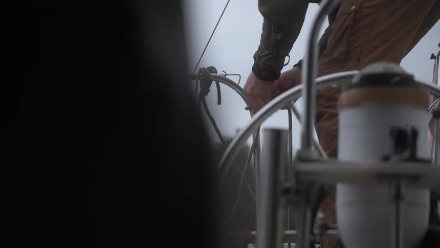 Person tying a rope to the boat