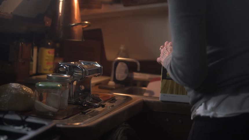A woman is unpacking a box in the boat
