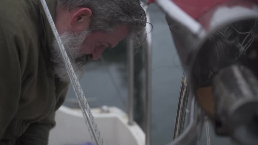 A footage of an elderly man at the dockyard