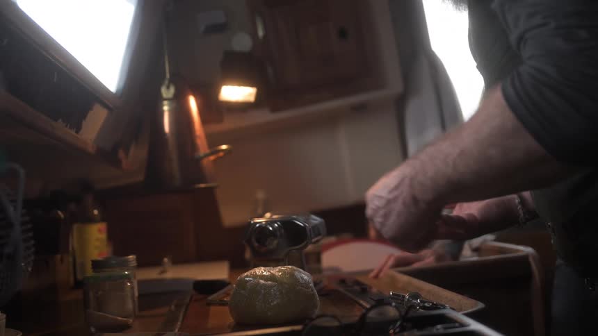 A man is cooking by his stove