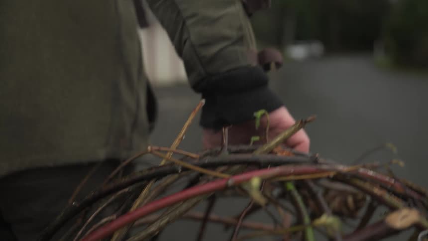 Person walking carrying a fishing trap