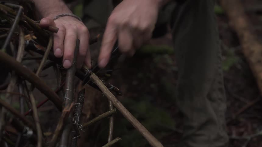 Hand with a knife cutting a wooden trap