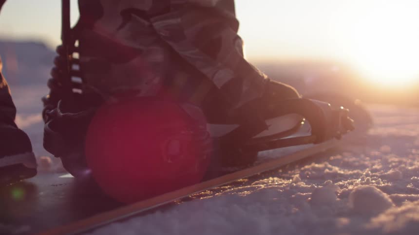 Strapping foot onto a snowboard