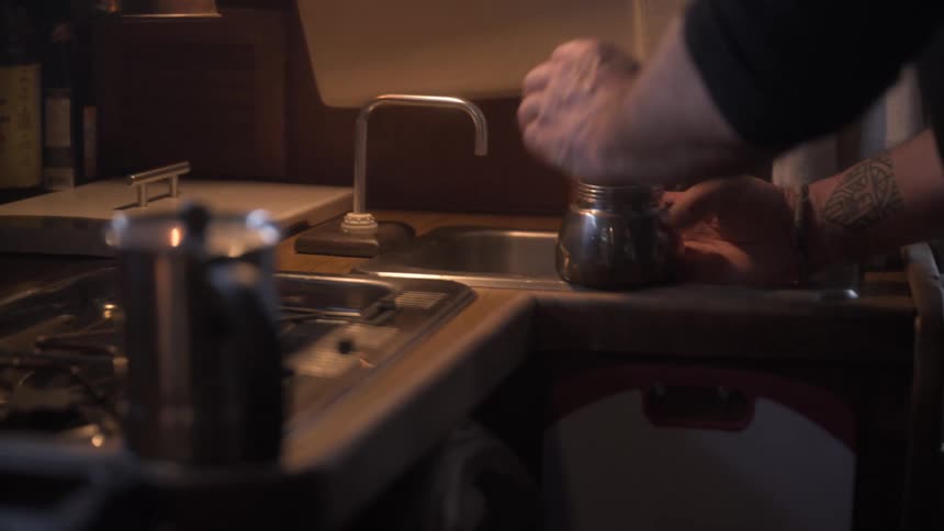 Hand filling a metal bottle with water