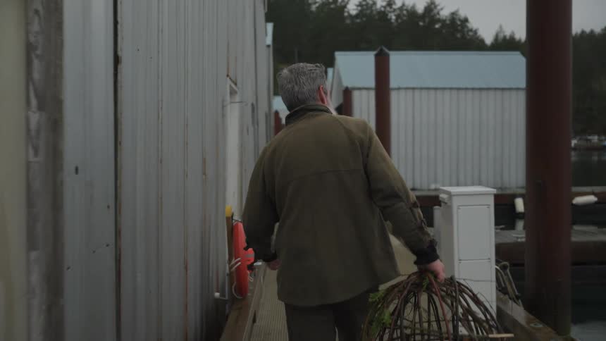 A footage of a man walking with a basket