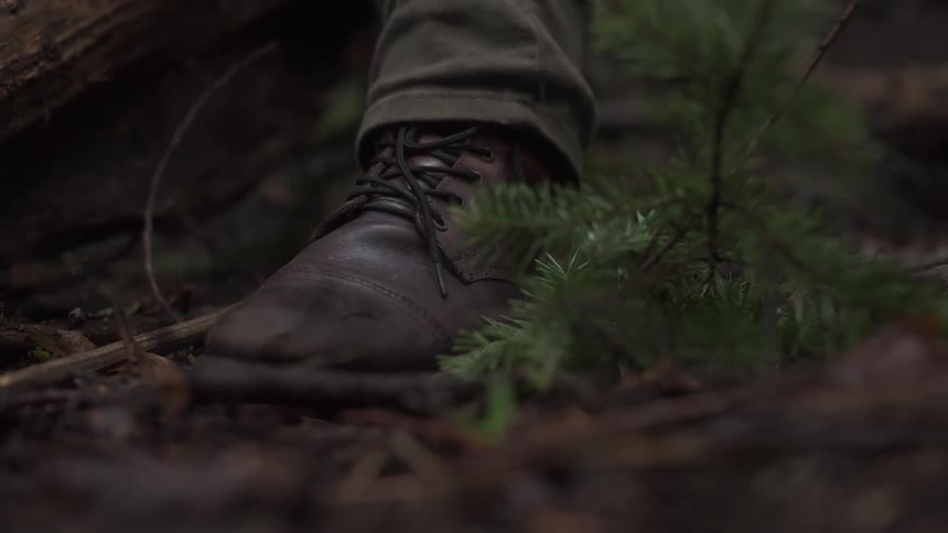 A person is wearing leather boots