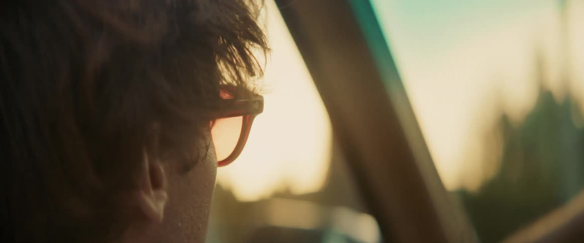 Man in sunglasses driving a vehicle