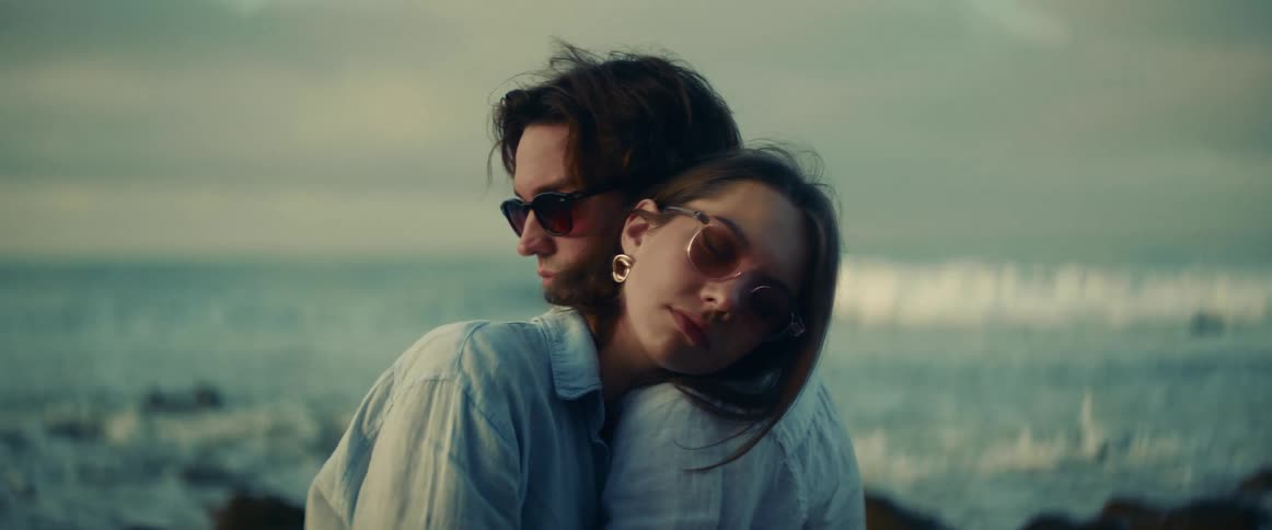 A couple are hugging on the beach