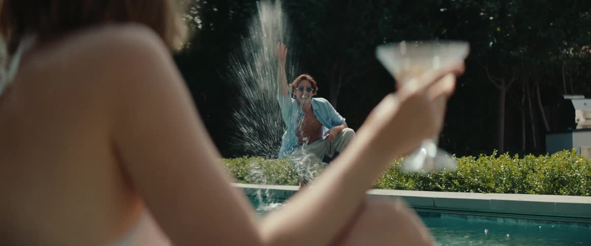 A footage of a male and female playing at the pool side