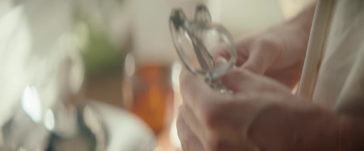 Hands closing a transparent glasses