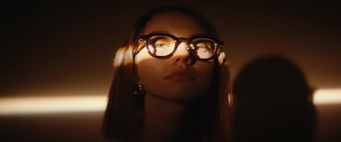 Portrait of a woman with a beam of light on her face