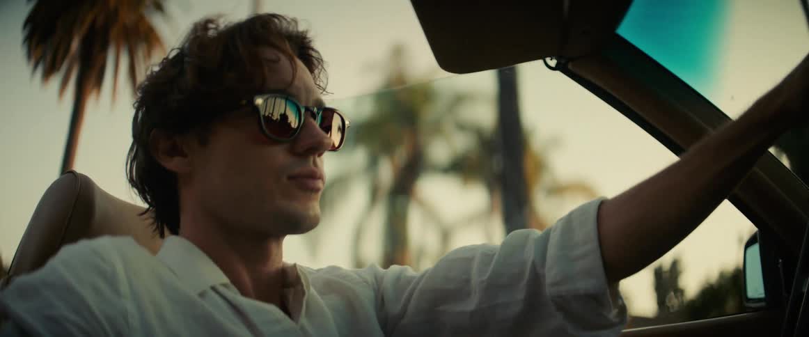 A footage of a man driving a car