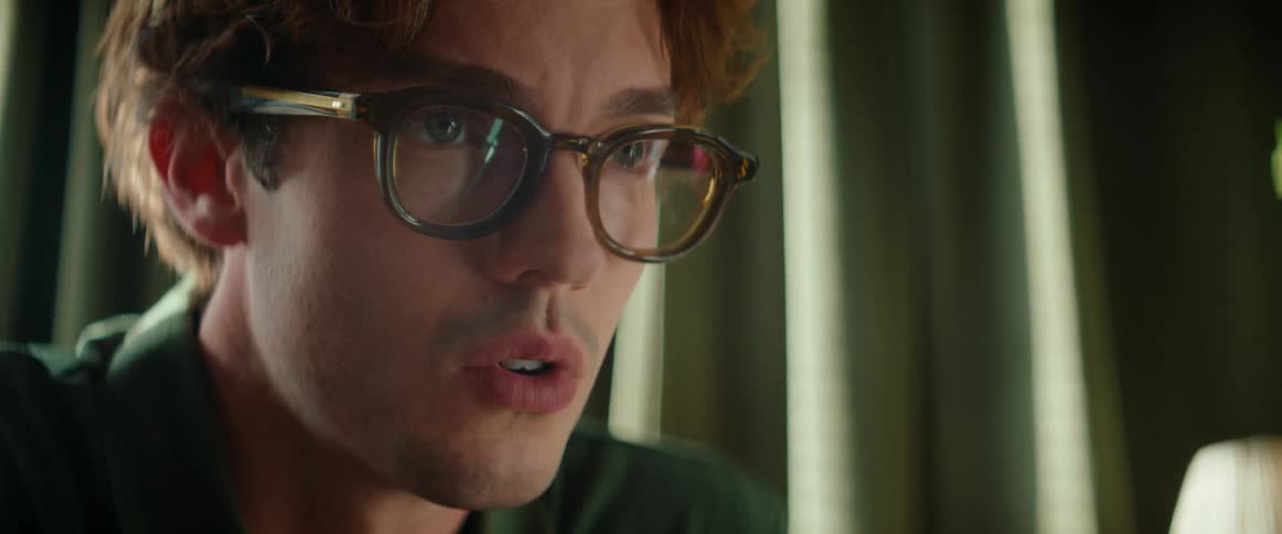 Portrait of a thoughtful man putting on prescription glasses