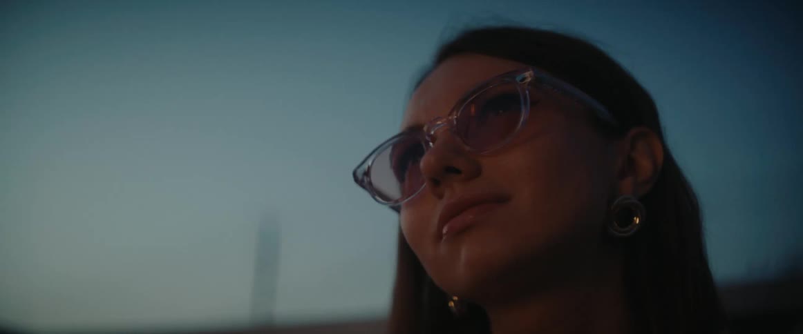 Portrait of a woman with glasses outdoors