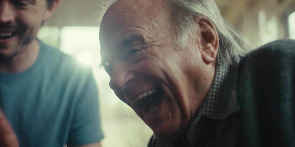 Elderly man and a young man smiling happily