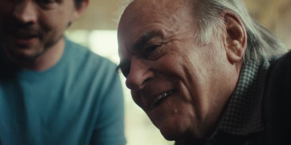 Elderly man with happy facial expression next to another man