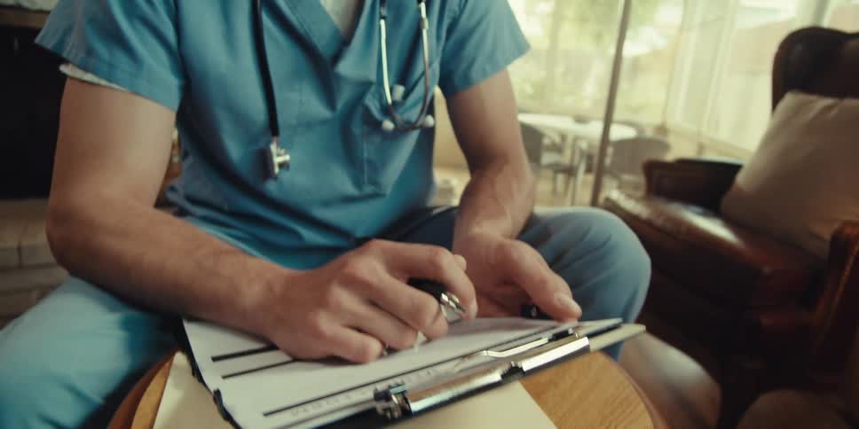 Nurse talking to someone and holding a clipboard