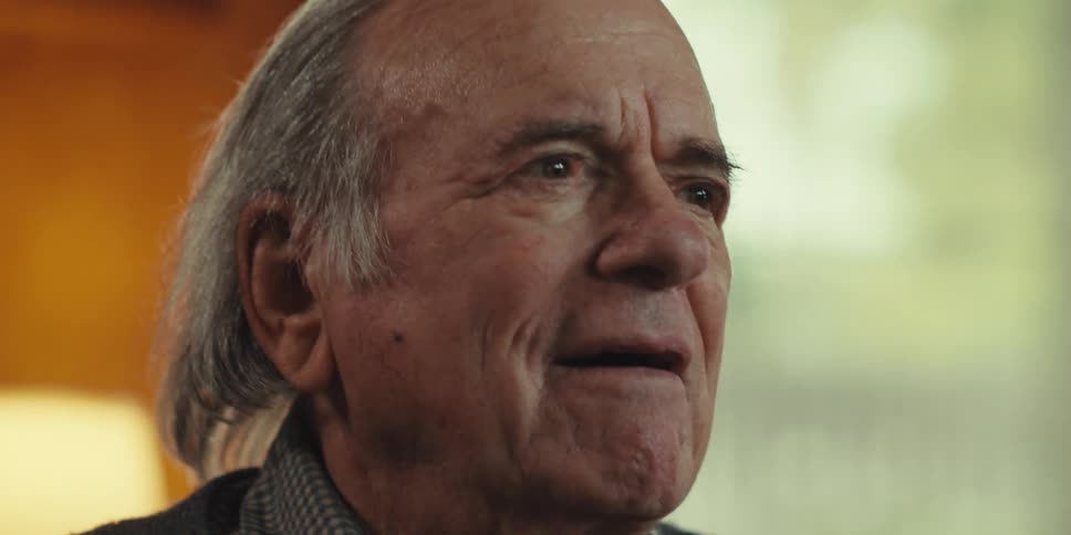 Elderly man with happy facial expression sitting