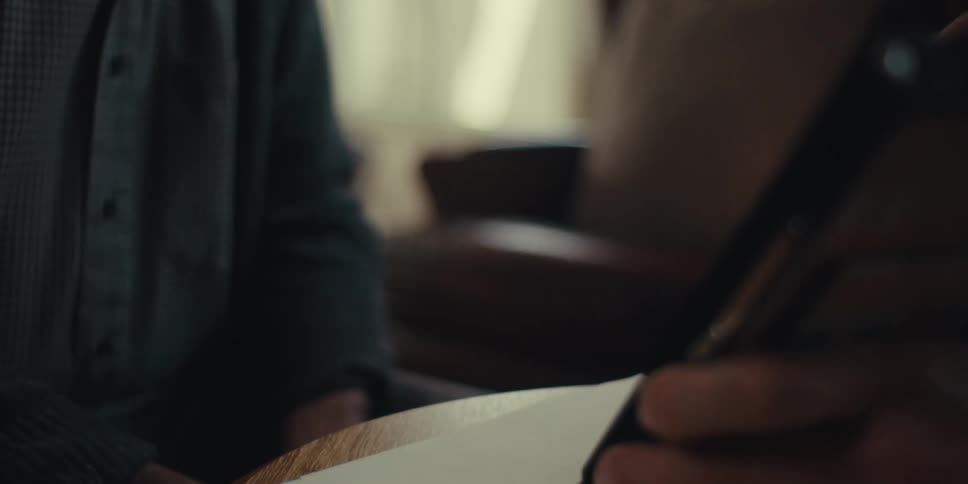 Elderly man paying attention to another person and interacting with a notepad