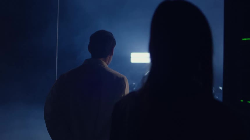 Woman and a man scientists observe an experiment with a vehicle