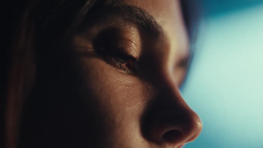 Closeup of a young woman blinking her eyes