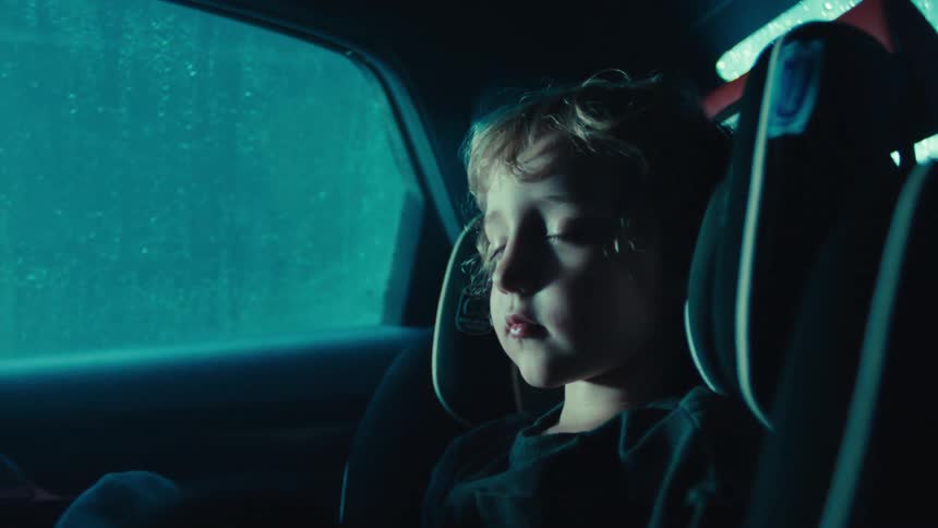 A child is sleeping in the back of the car