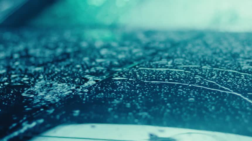 Water running down the hood of a car