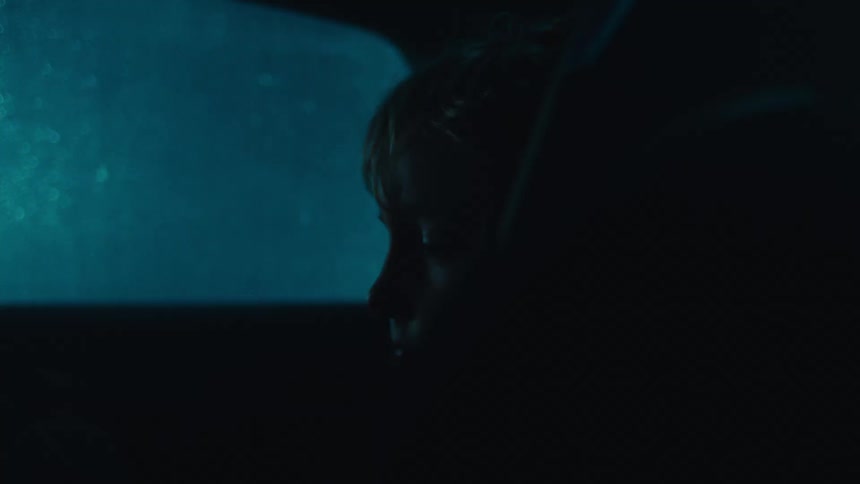 Silhouette of a little boy sleeping inside a car in the back seat