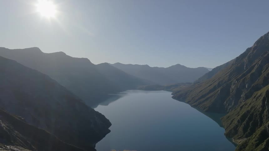 Natural scenery of a lake surrounded by mountains during the day