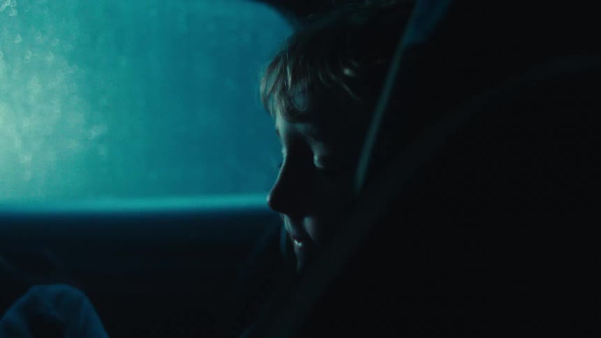 Child sleeping in a car seat in the back seat of a vehicle
