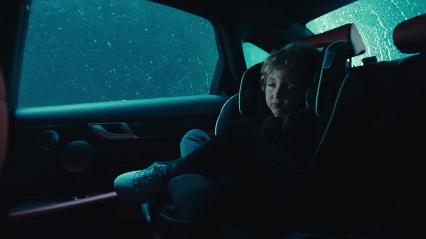 A footage of a child sleeping in a car